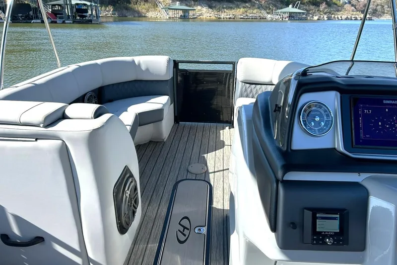 Slide: The Image of 2020 Harris FloteBote Solstice 230 interior with plush seating and modern dashboard on a lake. - 38
