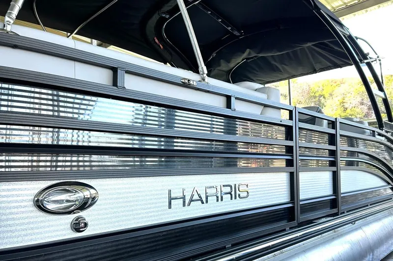 Slide: The Image of 2020 Harris FloteBote Solstice 230 pontoon boat with sleek design and black canopy. - 49