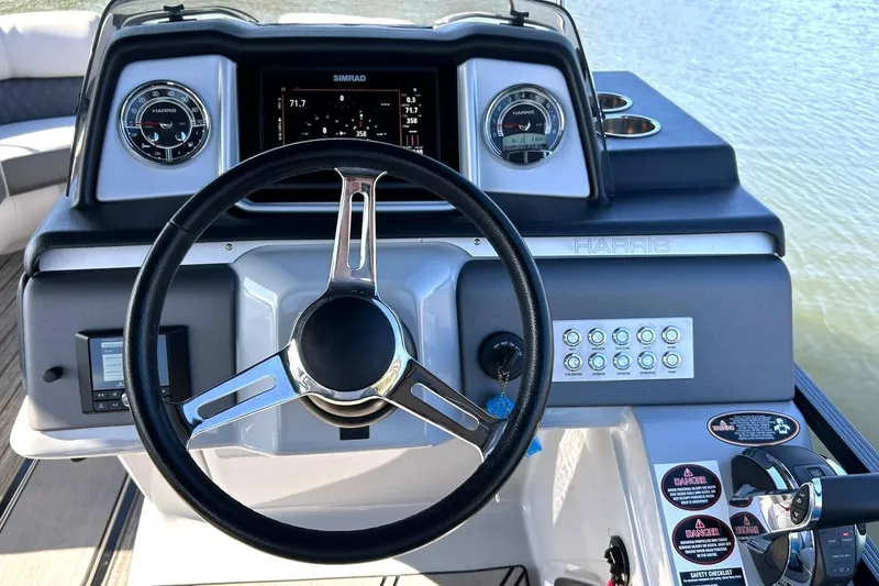Slide: The Image of 2020 Harris FloteBote Solstice 230 dashboard with steering wheel and control panel. - 5