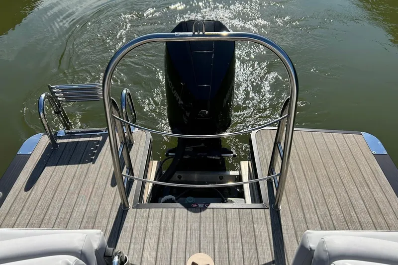 Slide: The Image of 2020 Harris FloteBote Solstice 230 pontoon boat rear view with motor and swim ladder. - 6