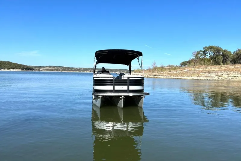 Slide: The Image of 2020 Harris FloteBote Solstice 230 pontoon boat on a serene lake. - 9