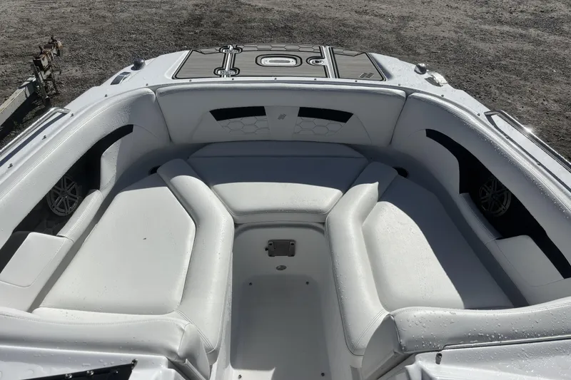 Slide: The Image of 2023 Four Winns HD3 boat interior with white cushioned seating and sleek design. - 12