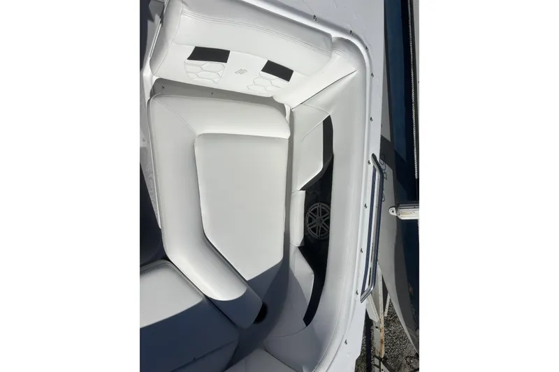 Slide: The Image of 2023 Four Winns HD3 boat interior with white cushioned seating. - 14