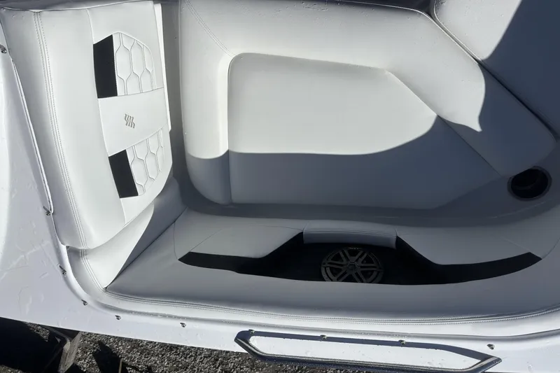 Slide: The Image of 2023 Four Winns HD3 boat interior with white seating and hexagonal pattern. - 15