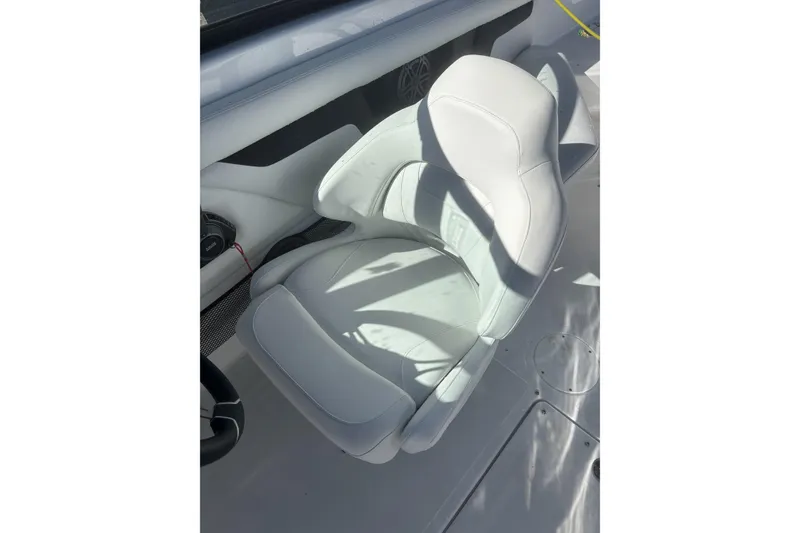 Slide: The Image of 2023 Four Winns HD3 boat seat, white leather, modern design, sunlight casting shadows. - 18