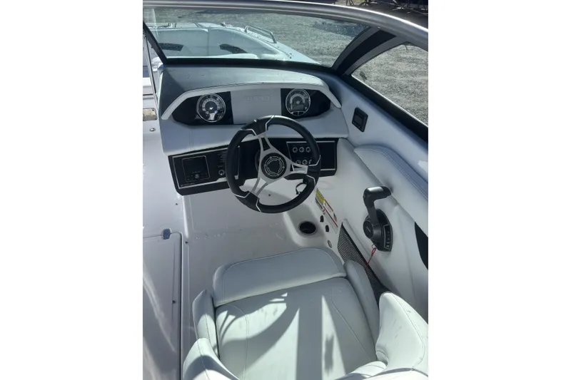 Slide: The Image of 2023 Four Winns HD3 boat interior with steering wheel and dashboard controls. - 20
