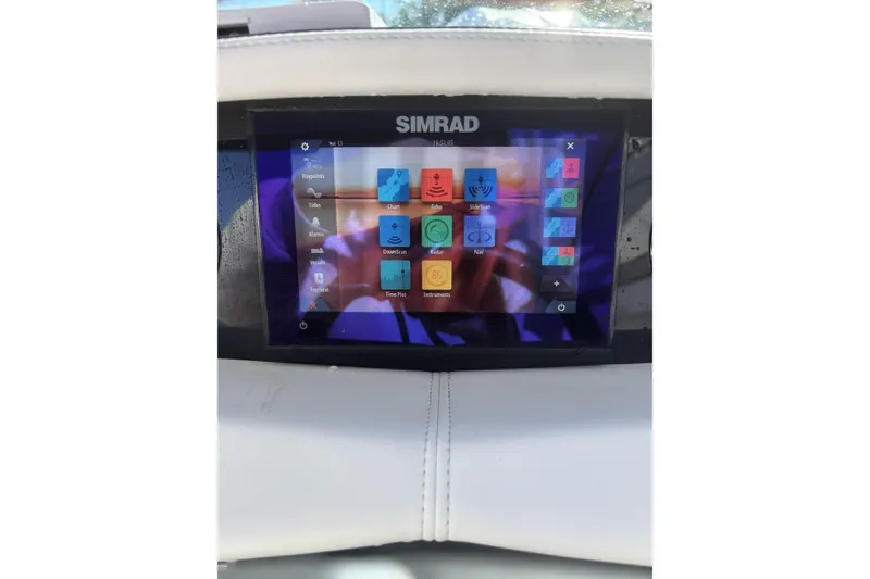 Slide: The Image of Simrad display on 2023 Four Winns HD3 boat dashboard, showing navigation and sonar options. - 21