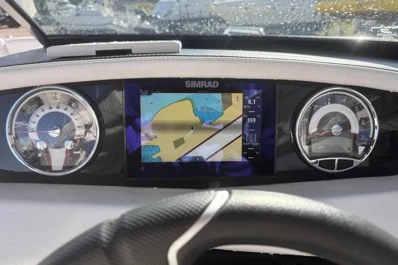 Slide: The Image of Dashboard of 2023 Four Winns HD3 boat with navigation display and gauges. - 22