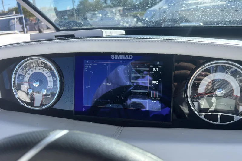 Slide: The Image of Dashboard of 2023 Four Winns HD3 boat with Simrad display and gauges. - 23