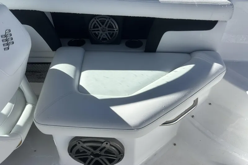 Slide: The Image of 2023 Four Winns HD3 boat interior with cushioned seating and built-in speaker. - 26