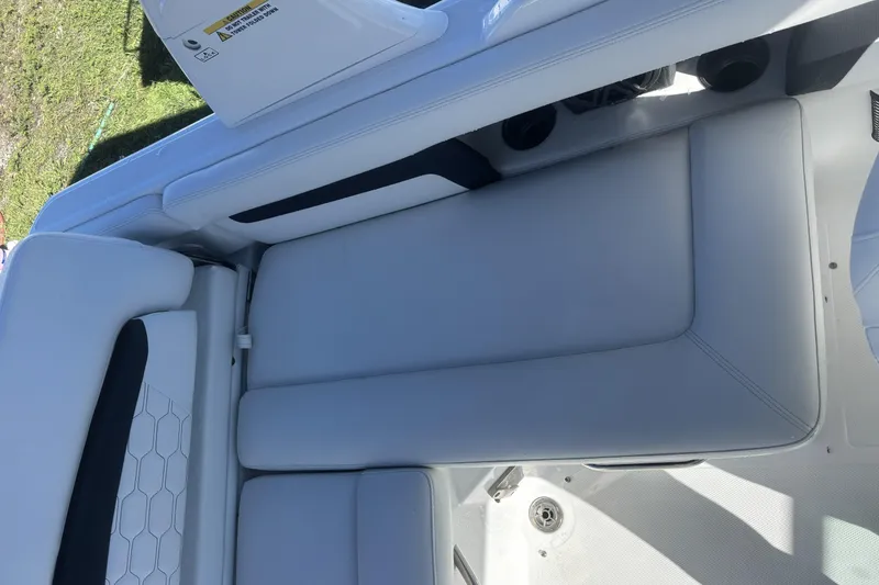 Slide: The Image of 2023 Four Winns HD3 boat interior with sleek white seating and modern design. - 27