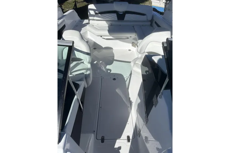 Slide: The Image of 2023 Four Winns HD3 boat interior with white seating and open deck layout. - 29