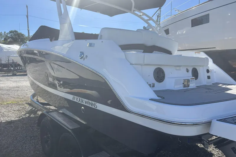 Slide: The Image of 2023 Four Winns HD3 boat on trailer, rear view in sunlight. - 3