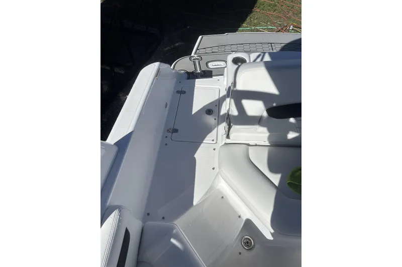 Slide: The Image of 2023 Four Winns HD3 boat interior with white seating and storage compartments. - 31