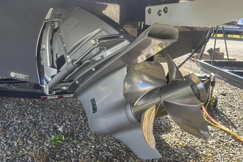 Slide: The Image of 2023 Four Winns HD3 boat propeller and drive system on gravel surface. - 6