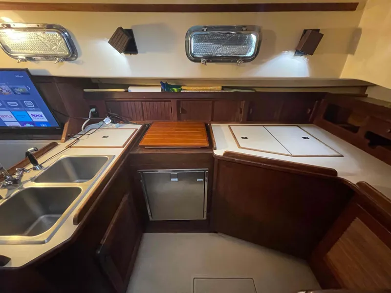 Slide: The Image of Interior of 1990 Island Packet 35 Cutter yacht kitchen with sink and stove. - 10