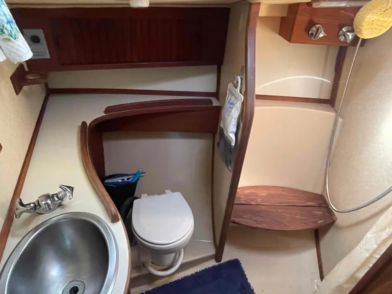 Slide: The Image of Island Packet 35 Cutter 1990 bathroom with sink, toilet, and shower. - 12