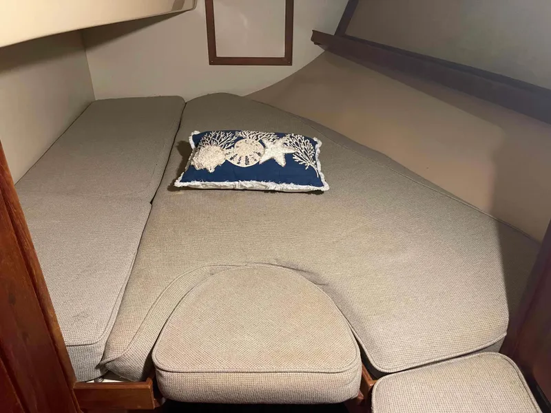 Slide: The Image of Island Packet 35 Cutter 1990 interior cabin with bed and decorative pillow. - 14