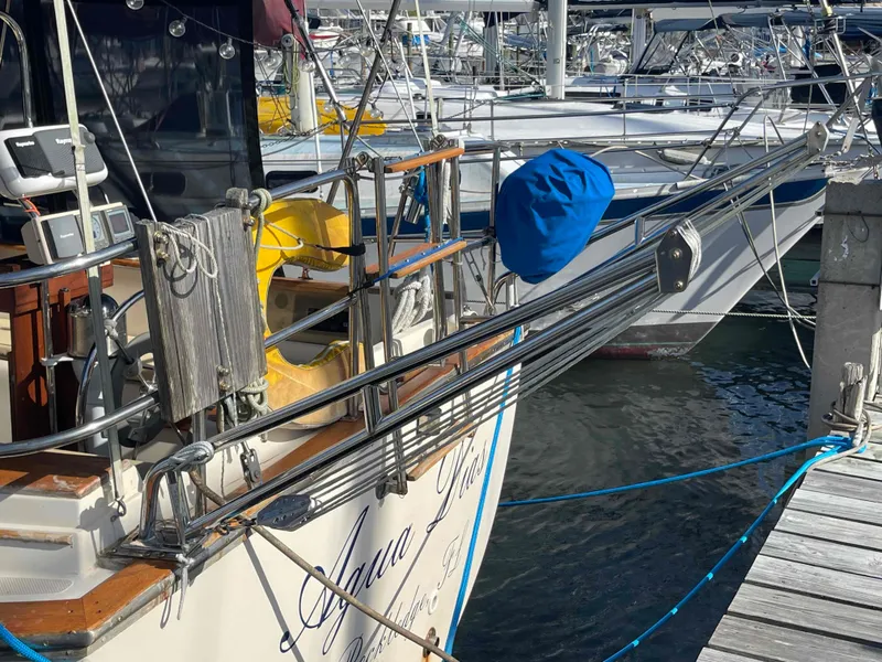 Slide: The Image of Interior of 1990 Island Packet 35 Cutter sailboat with beige seating and wooden accents. - 18