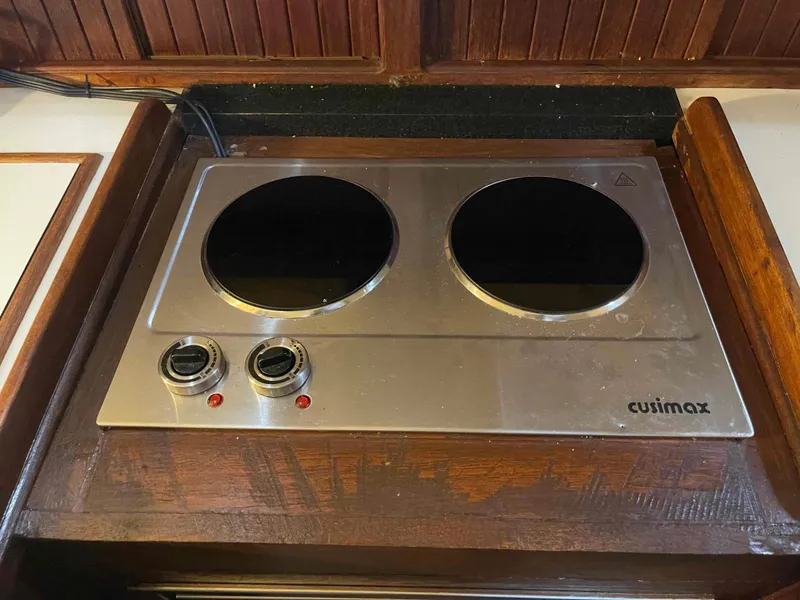 Slide: The Image of 1990 Island Packet 35 Cutter galley with dual sink, stove, and compact fridge. - 29