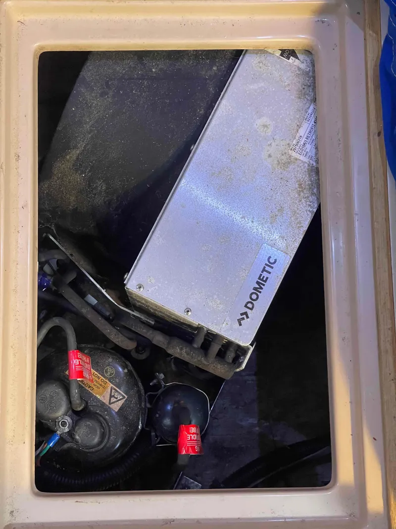 Slide: The Image of Island Packet 35 Cutter 1990 galley with wood cabinetry and stainless steel appliances. - 30