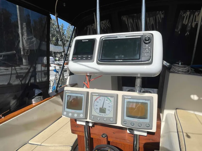Slide: The Image of Engine compartment of a 1990 Island Packet 35 Cutter sailboat, showing hoses and metal fittings. - 37