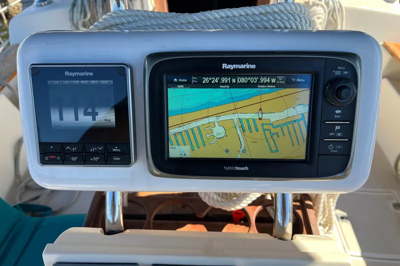 Slide: The Image of Engine compartment of a 1990 Island Packet 35 Cutter sailboat, showcasing mechanical components. - 38