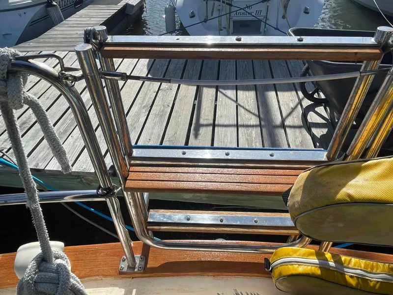 Slide: The Image of Engine compartment of 1990 Island Packet 35 Cutter with marine exhaust system. - 42