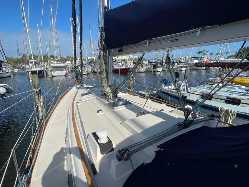 Slide: The Image of 1990 Island Packet 35 Cutter sailboat cockpit with helm and seating. - 43