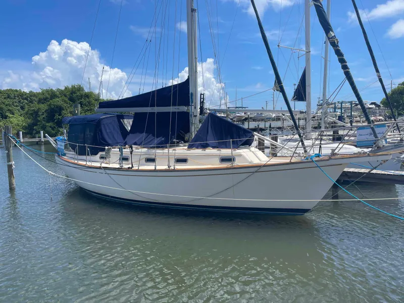 Slide: The Image of 1990 Island Packet 35 Cutter sailboat docked in sunny marina. - 5