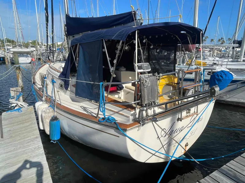 Slide: The Image of 1990 Island Packet 35 Cutter sailboat docked at a marina. - 56