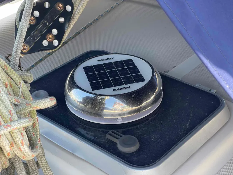 Slide: The Image of 1990 Island Packet 35 Cutter sailboat bow with blue ropes and anchor. - 59