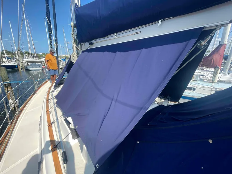Slide: The Image of 1990 Island Packet 35 Cutter sailboat docked at a marina. - 60