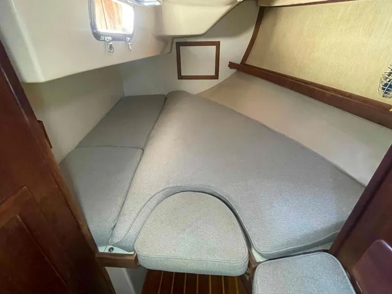 Slide: The Image of 1990 Island Packet 35 Cutter sailboat with blue sail cover in marina. - 62