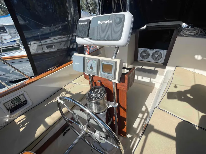 Slide: The Image of 1990 Island Packet 35 Cutter cockpit with Raymarine navigation equipment. - 7