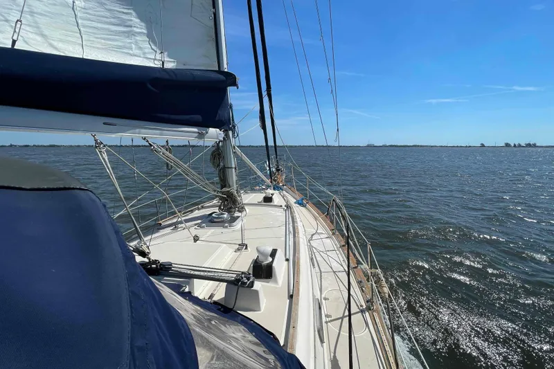 Slide: The Image of Sailing on a 1990 Island Packet 35 Cutter under clear blue skies. - 80