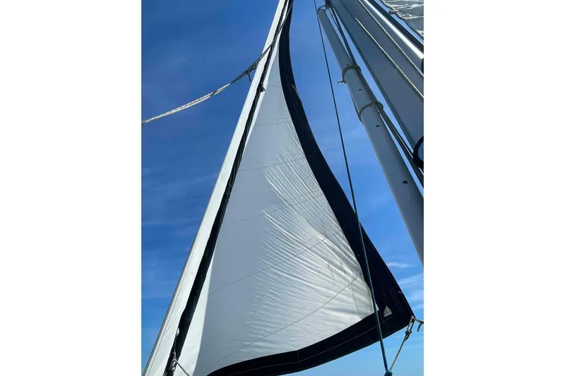 Slide: The Image of Sail of 1990 Island Packet 35 Cutter against clear blue sky. - 83