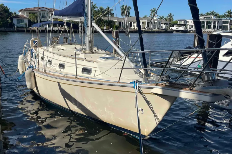 Slide: The Image of 1990 Island Packet 35 Cutter sailboat docked in a marina. - 89