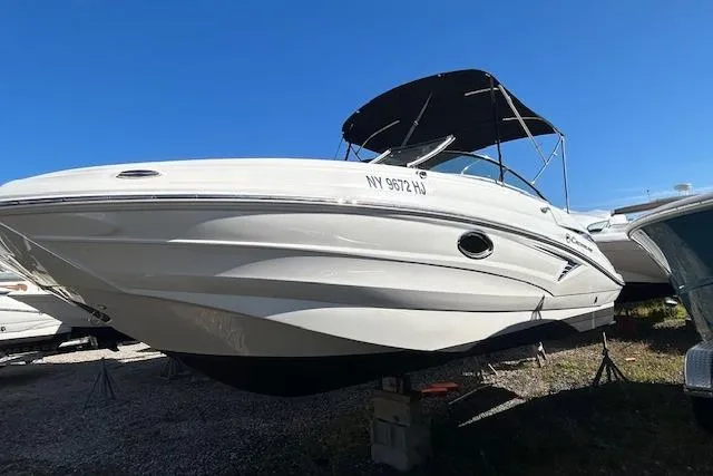 The Image of 2023 Crownline Eclipse E235 XS boat with canopy, displayed on stands. - 0