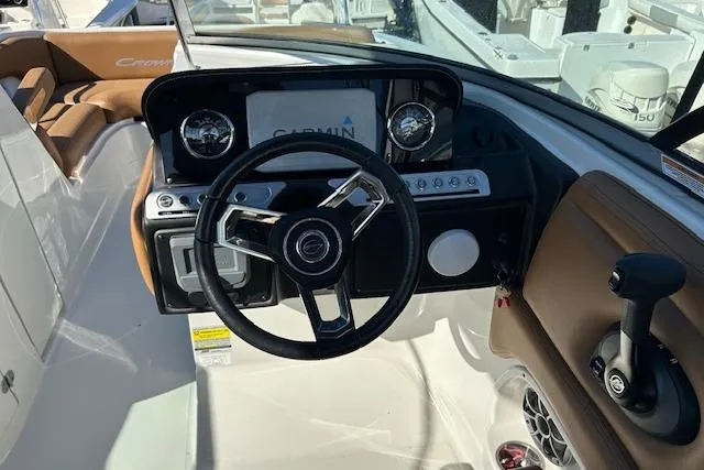 Slide: The Image of 2023 Crownline Eclipse E235 XS boat dashboard with steering wheel and Garmin display. - 5