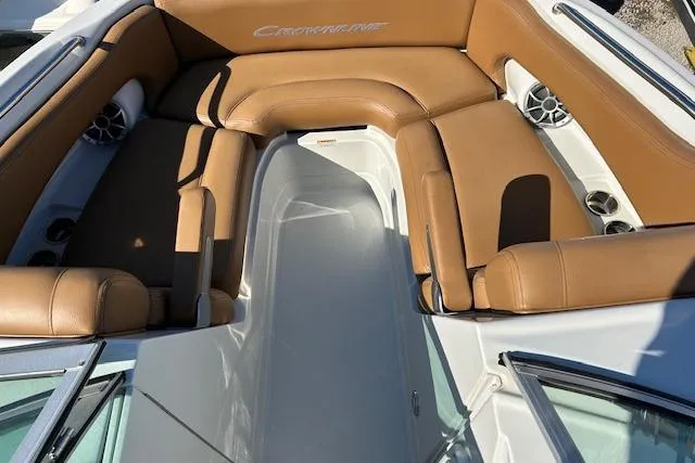 Slide: The Image of 2023 Crownline Eclipse E235 XS boat interior with tan seating and speakers. - 6