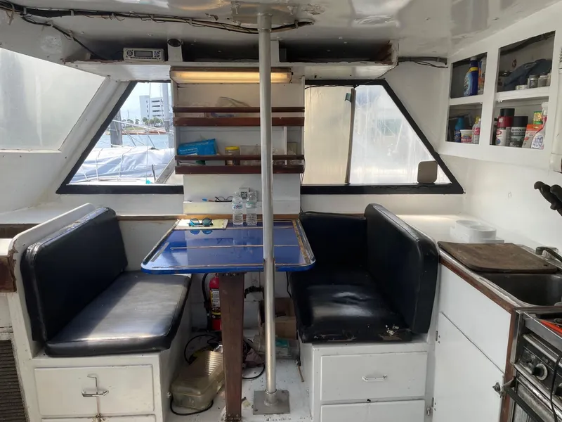 Slide: The Image of Interior of 1983 Commercial Hull #1 Key West boat with seating and kitchenette. - 12