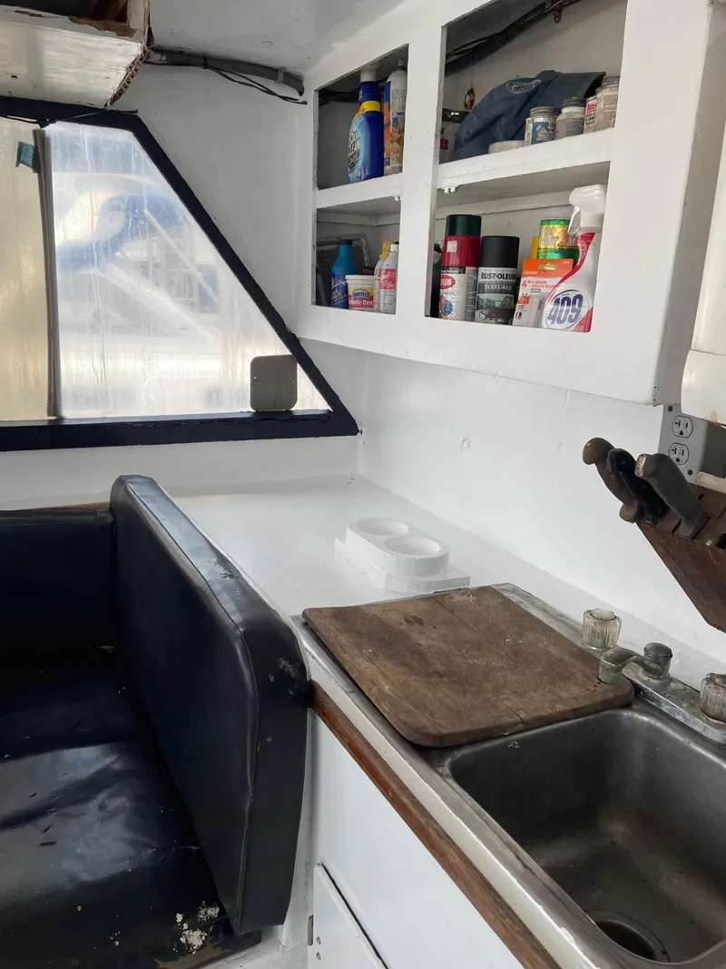 Slide: The Image of Interior of 1983 Commercial Hull #1 Key West boat with kitchenette and seating area. - 4