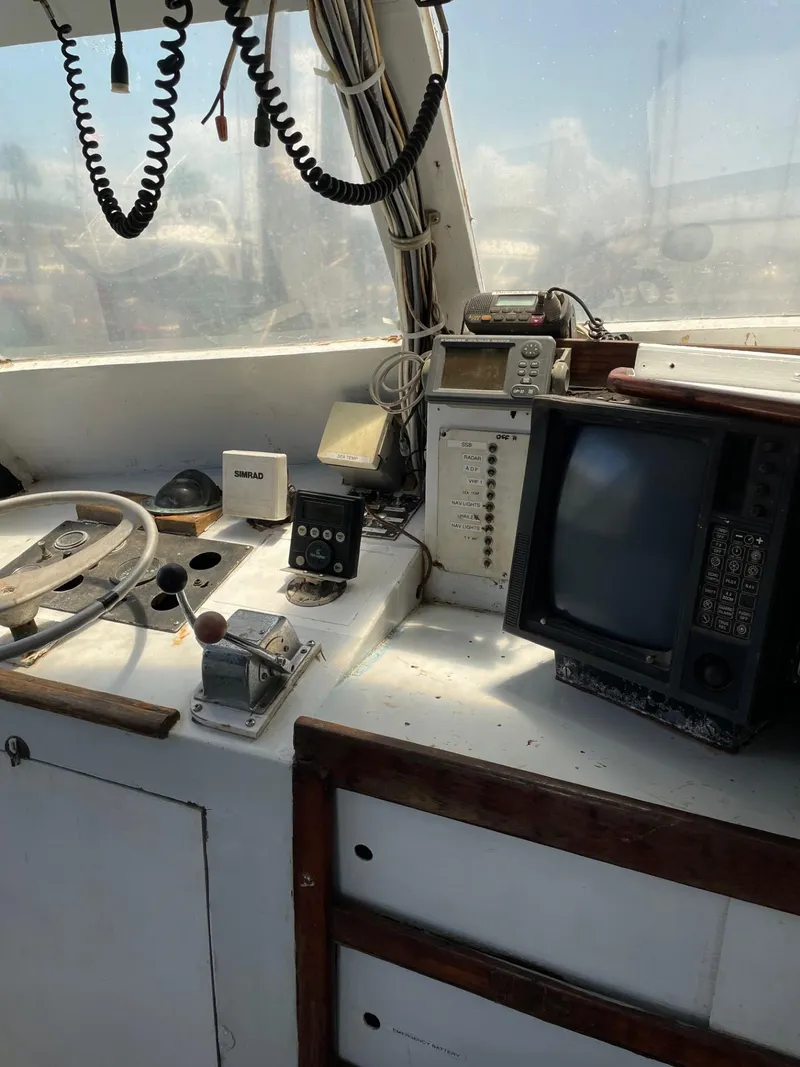 Slide: The Image of 1983 Commercial Hull #1 Key West boat cockpit with vintage navigation equipment. - 9