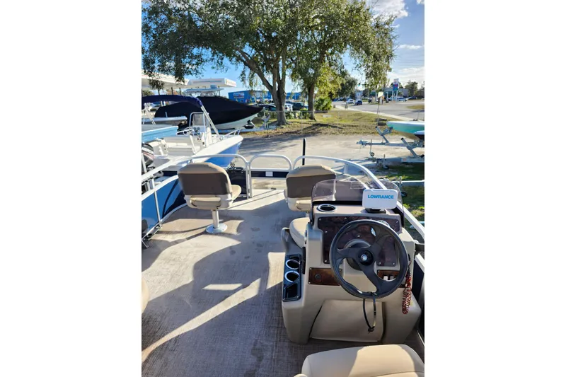 Slide: The Image of 2022 Sun Tracker Bass Buggy 16 XL Select pontoon boat interior with steering console. - 10