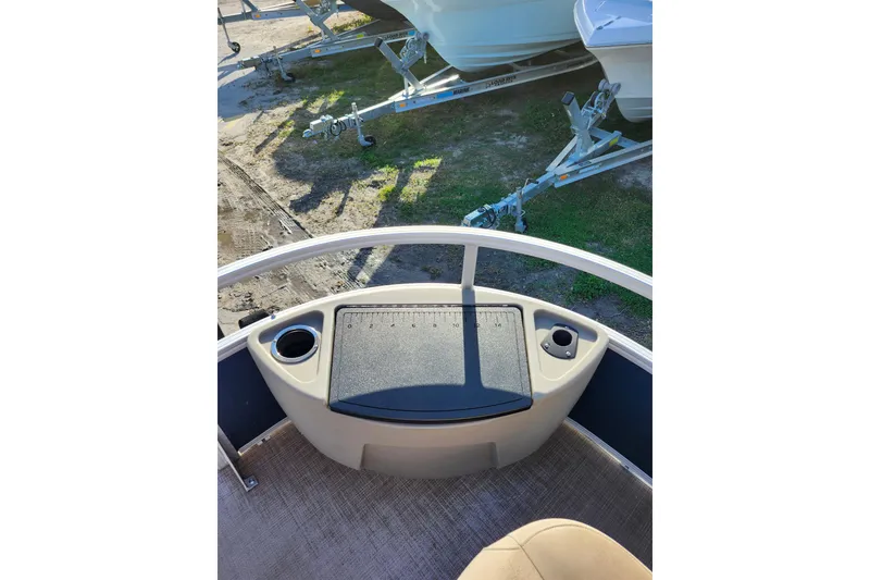 Slide: The Image of 2022 Sun Tracker Bass Buggy 16 XL Select boat deck with cup holders and storage. - 11