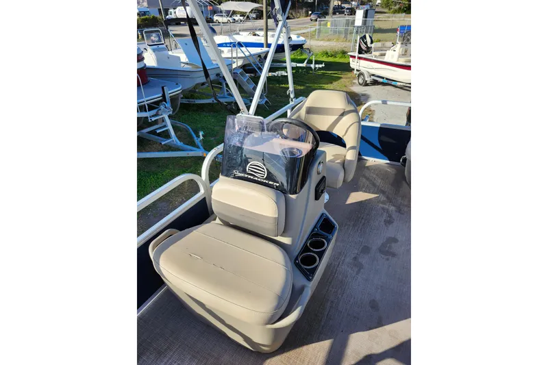 Slide: The Image of 2022 Sun Tracker Bass Buggy 16 XL Select interior with beige seating and console. - 14