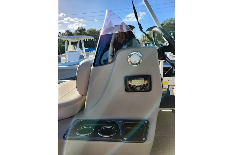 Slide: The Image of 2022 Sun Tracker Bass Buggy 16 XL Select console with steering wheel and cup holders. - 15