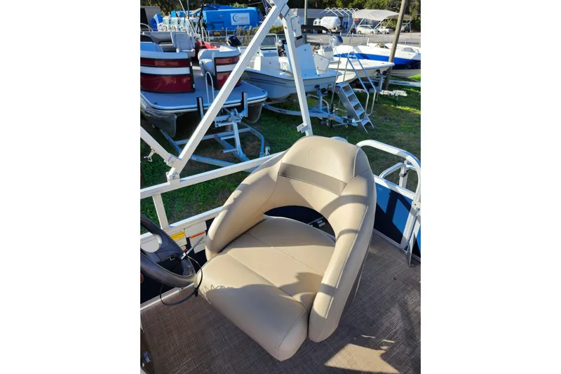 Slide: The Image of 2022 Sun Tracker Bass Buggy 16 XL Select boat seat, beige upholstery, outdoor display. - 17