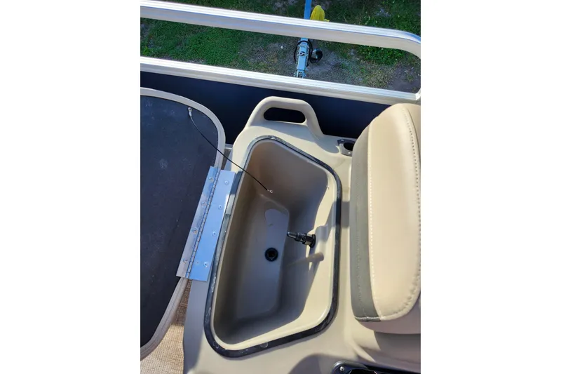Slide: The Image of 2022 Sun Tracker Bass Buggy 16 XL Select storage compartment with open lid. - 18